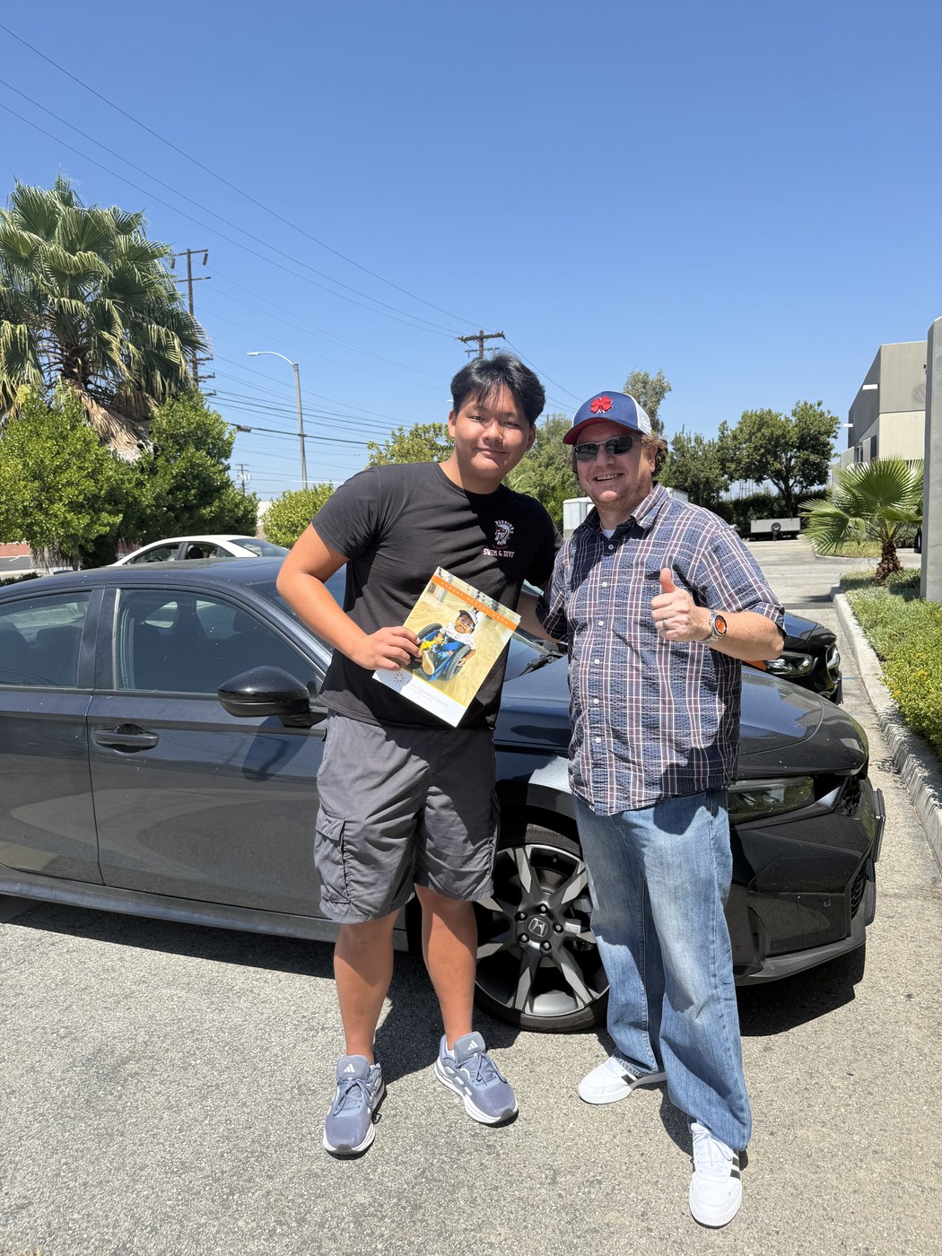Ashton H. Jung and Scott Kasell of the Blind Children's Center after the book delivery